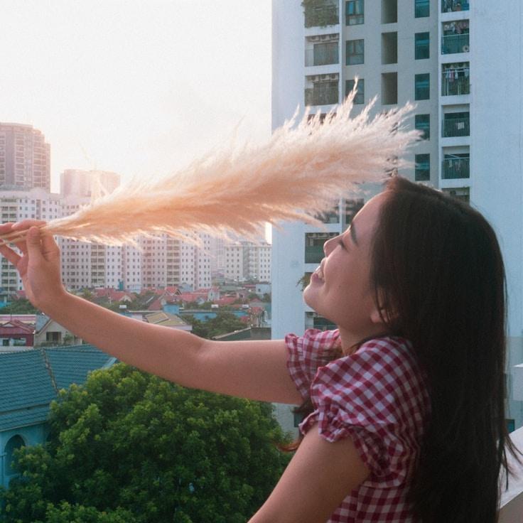 Mira Solanki, Lead Design Curator at Garden Parcel Stone, reviewing corporate floral arrangements